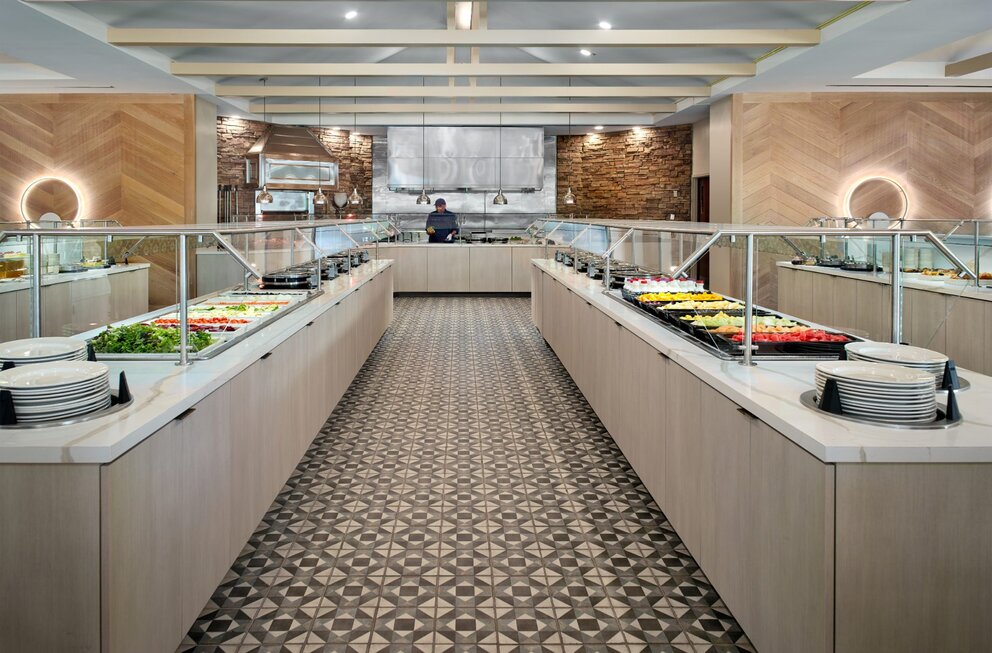A buffet dining area with food and plates